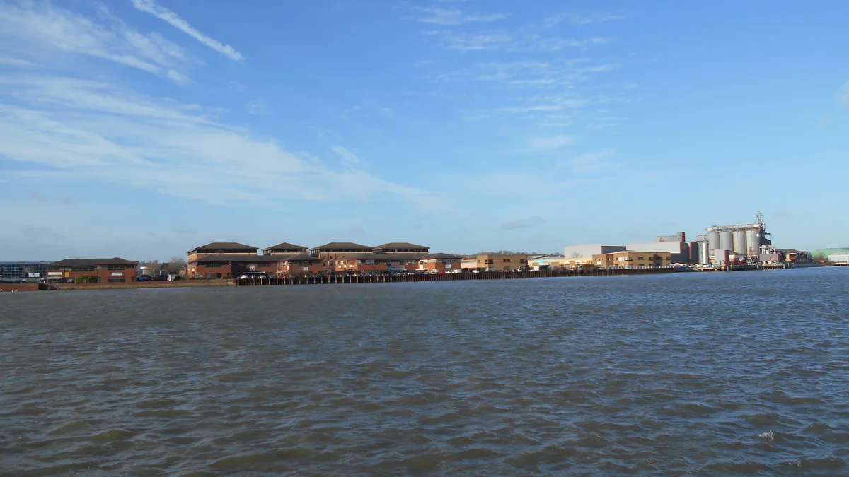 Office buildings, industrial units and riverside silos of the Medway City Estate seen across the River Medway at Frindsbury